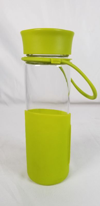 Photo 1 of CLEAR GLASS WATER BOTTLE WITH GREEN SILICONE BOTTOM AND PLASTIC TOP 2.5D X 8.5H INCHES NEW