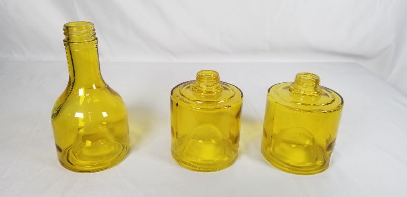 Photo 2 of STACKING YELLOW GLASS BOTTLE 13H INCHES NEW