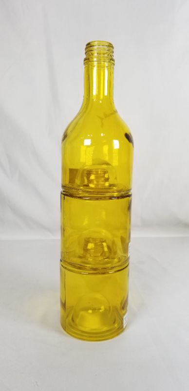 Photo 1 of STACKING YELLOW GLASS BOTTLE 13H INCHES NEW