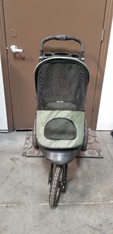 Photo 2 of GREEN AND BLACK 3 WHEEL PET STROLLER  WITH 2 CUP HOLDERS AND AN UNDER BASKET USED 