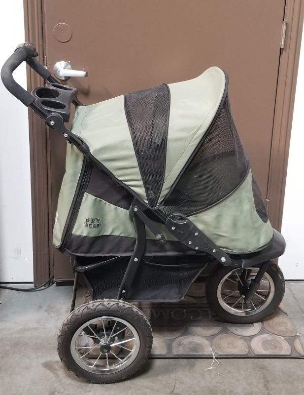Photo 3 of GREEN AND BLACK 3 WHEEL PET STROLLER  WITH 2 CUP HOLDERS AND AN UNDER BASKET USED 
