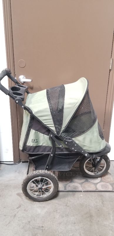 Photo 4 of GREEN AND BLACK 3 WHEEL PET STROLLER  WITH 2 CUP HOLDERS AND AN UNDER BASKET USED 