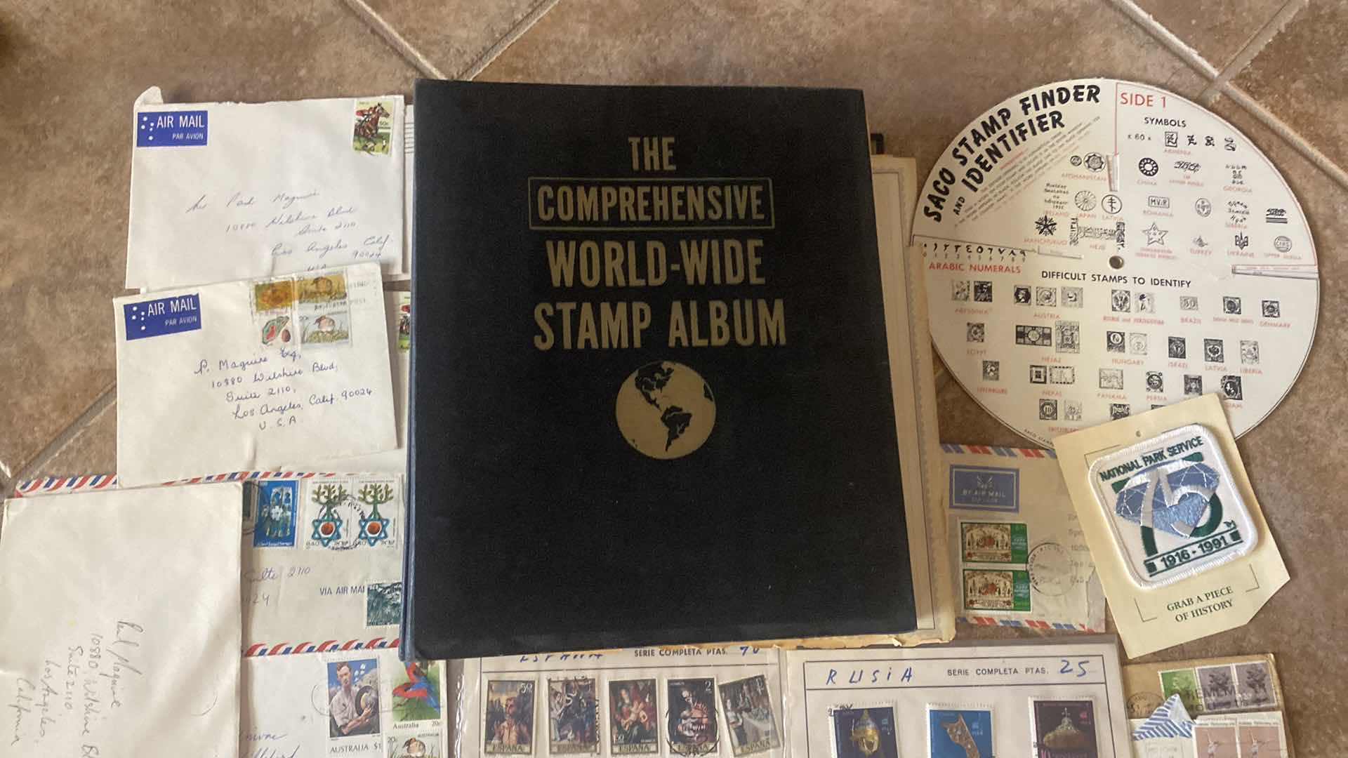 Photo 1 of THE COMPREHENSIVE WORLDWIDE STAMP ALBUM WITH ASSORTMENT OF STAMPS