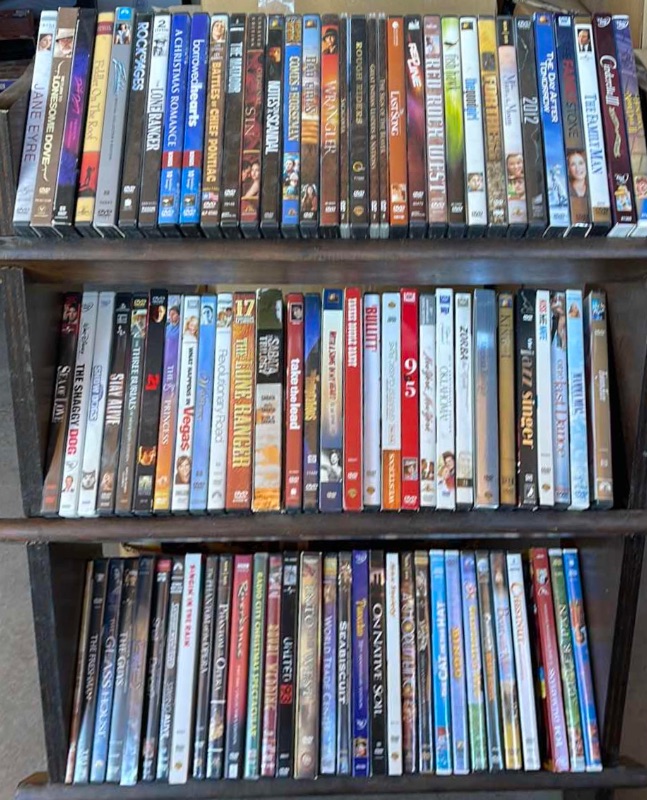 Photo 1 of DVDS W/ STAND MOSTLY WATCHED ONCE OR NEW 