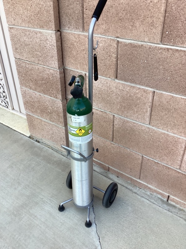 Photo 1 of COMPRESSED OXYGEN TANK WITH ROLLER