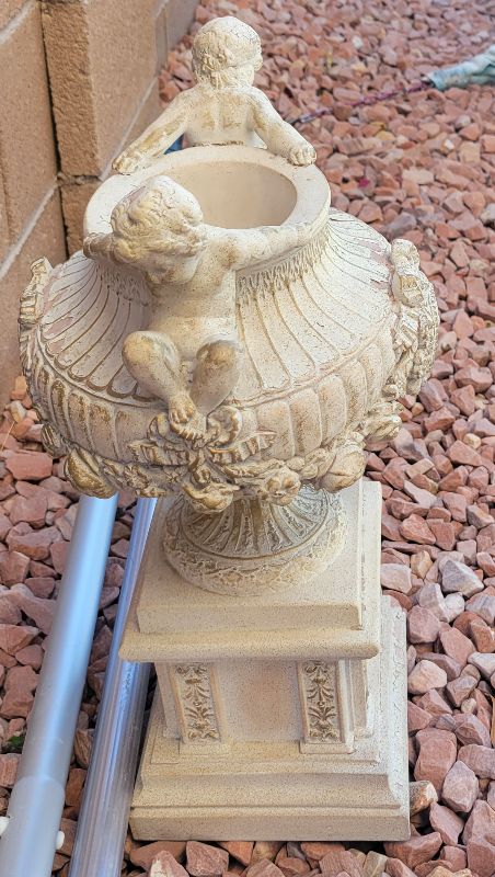 Photo 1 of URN WITH CHERUBS 12” TALL