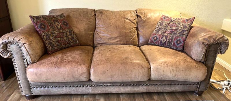 Photo 1 of 6’ TAN DISTRESSED LEATHER SOFA W NAILHEADS STUDDED TRIM (SEE PICTURES FOR WEAR)