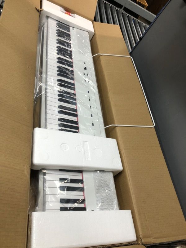 Photo 2 of Alesis Recital – 88 Key Digital Piano Keyboard with Semi Weighted Keys, 5 Voices, Piano Lessons, M-Audio Sustain Pedal and HDH40 Piano Headphones Recital White Piano + Sustain Pedal + Headphones