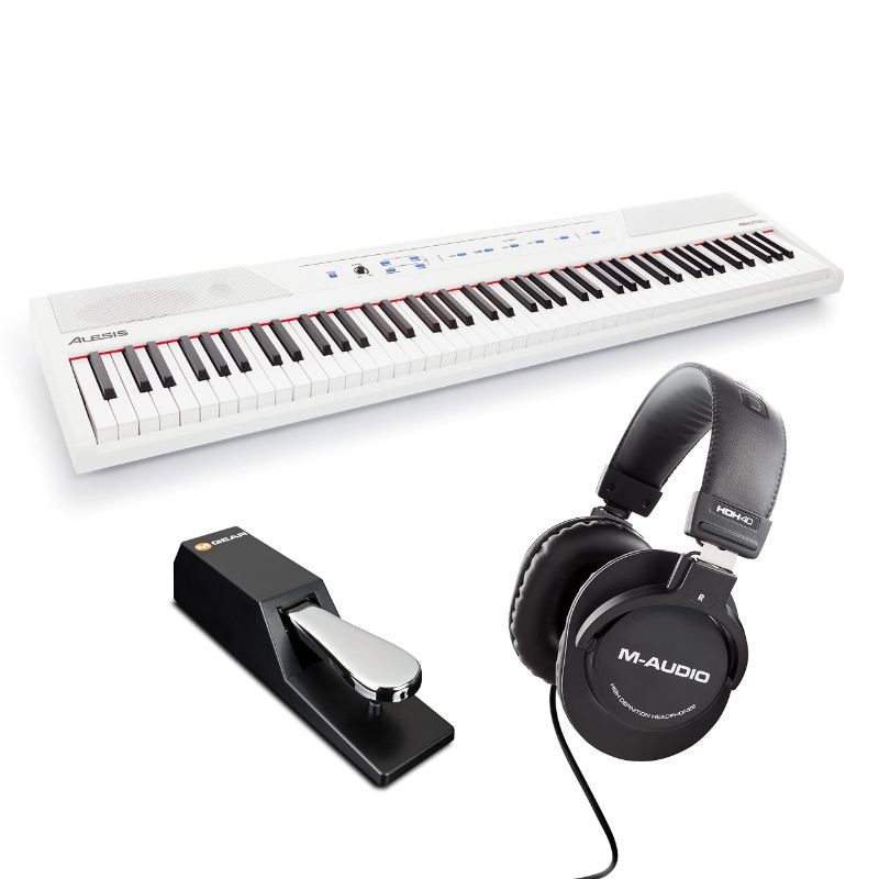 Photo 1 of Alesis Recital – 88 Key Digital Piano Keyboard with Semi Weighted Keys, 5 Voices, Piano Lessons, M-Audio Sustain Pedal and HDH40 Piano Headphones Recital White Piano + Sustain Pedal + Headphones