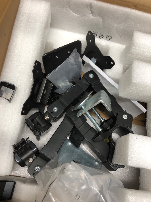 Photo 4 of *****USED AND HAS LOOSE HARDWARE*****  Amazon Basics Dual Monitor Stand, Lift Engine Arm Mount, Black