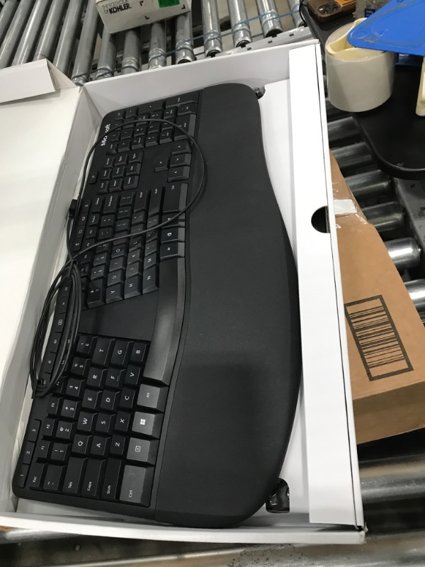 Photo 2 of Microsoft Ergonomic Keyboard - Black. Wired, Comfortable, Ergonomic Keyboard with Cushioned Wrist and Palm Support. Split Keyboard. Dedicated Office Key.
