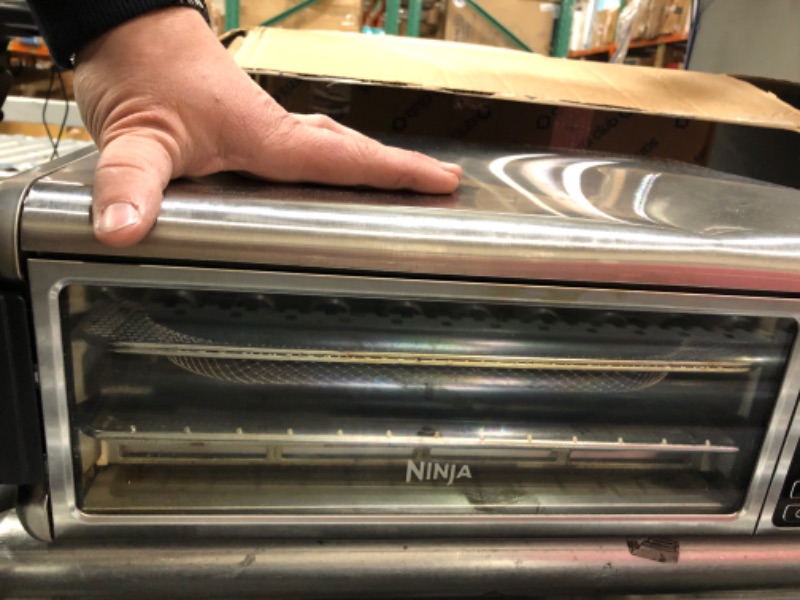 Photo 1 of Ninja SP101 Digital Air Fry Countertop Oven with 8-in-1 Functionality, Flip Up & Away Capability for Storage Space, with Air Fry Basket, Wire Rack & Crumb Tray, Silver

