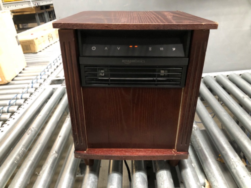 Photo 1 of Amazon Basics Cabinet Style Space Heater, Brown Wood Grain Finish, 1500W
damed to top of heater
