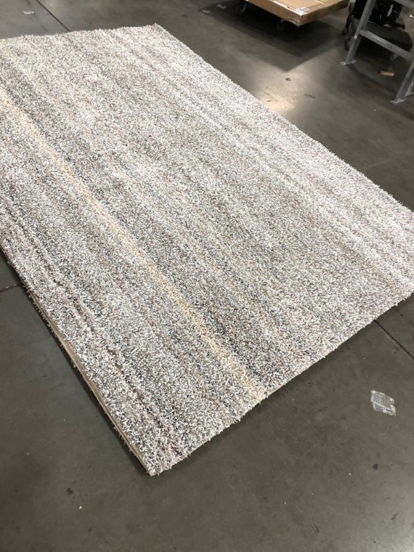 Photo 2 of **USED-NEEDS CLEANING**
**8' 9" X 12FT white grey beige rug, view photos for detail**
