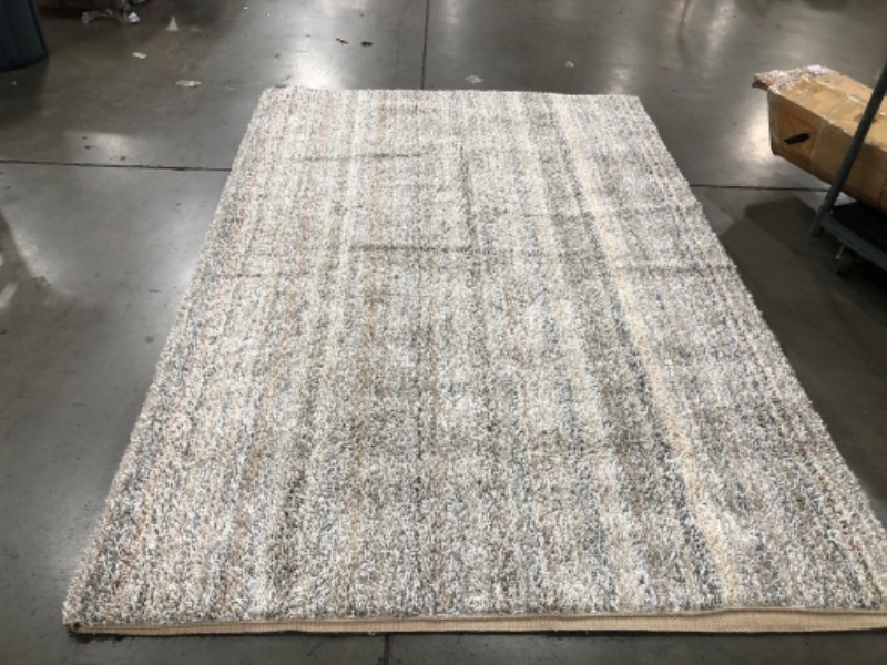 Photo 1 of **USED-NEEDS CLEANING**
**8' 9" X 12FT white grey beige rug, view photos for detail**
