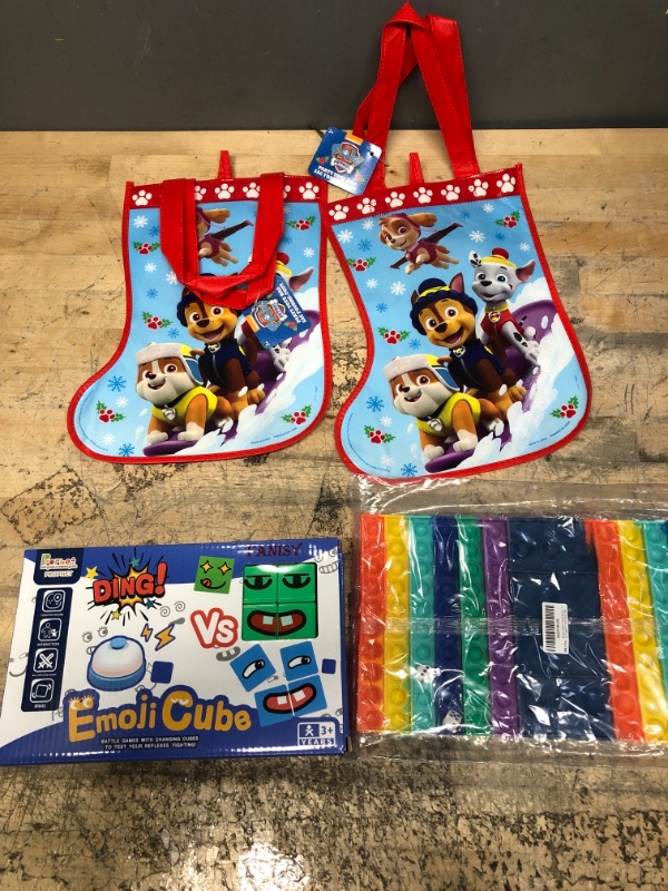 Photo 1 of BUNDLE OF 4*  KID ITEMS, 2 REUSABLE CHIRSTMAS BAGS, 1 FIDGET TOY, EMOJI CUBE 