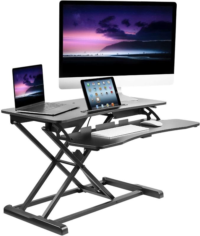 Photo 1 of  Adjustable Standing Desk Converter With Keyboard Tray, Ergonomic Tabletop Sit Stand Worksation 31.5 Wide for Desktop and Laptop Computers
