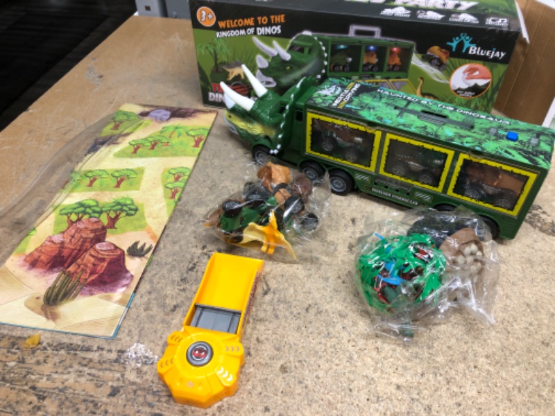 Photo 2 of BLUEJAY 21 Pack Dinosaur Toys for Kids 3-7, Dinosaur Truck with Oversized Dinosaur Map, Flashing Lights, Music and Roaring Sound, Kids Toys with 6 Pull Back Dinosaur Cars, 6 Dinosaur Toys (Green)