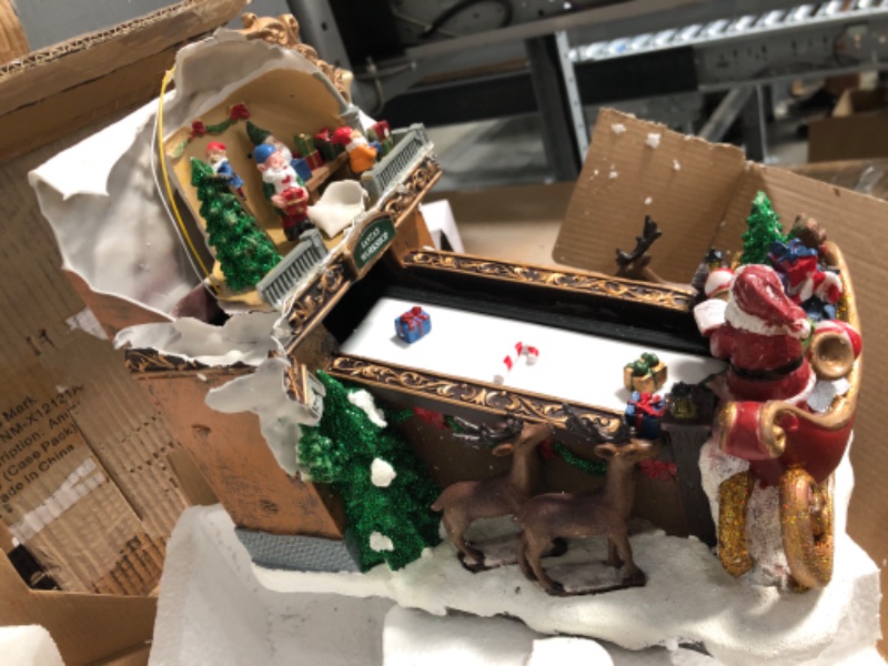 Photo 4 of **UNIT DAMAGED** Moments In Time Christmas Village Building, Santa's Toy Shop Conveyer Belt Loading his Sleigh with Christmas Music, LED Lights, and Animation - Power Adapter (Included) (10.4" H x 7.2" W x 10.6" D)
