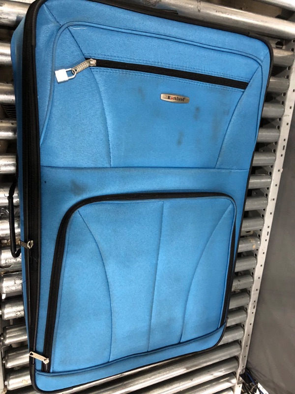 Photo 2 of **KEYS ARE IN POCKET TO LARGER SUITCASE, BRAND TAG IS FALLING OFF. SEE PHOTOS**
Rockland Journey Softside Upright Luggage Set, Blue, 4-Piece (14/19/24/28) 4-Piece Set (14/19/24/28) Blue