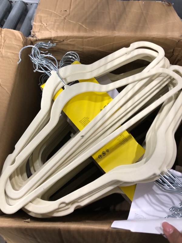 Photo 2 of Amazon Basics Slim, Velvet, Non-Slip Suit Clothes Hangers, Ivory/Beige- Pack of 100 Ivory/Beige 100-Pack Suit Hangers