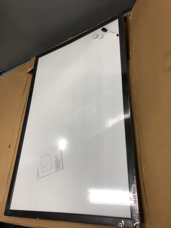 Photo 3 of ***Back of dry erase board has a few cracks in cardboard** does not effect useage of dry erase board 
Amazon Basics Magnetic Dry Erase White Board, 35 x 23-Inch Whiteboard - Black Wooden Frame 23"x35" Magnetic, Wood Frame