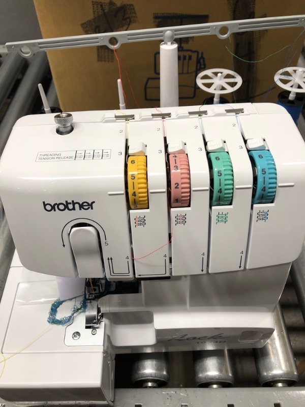 Photo 2 of *** POWERS ON *** Brother Serger, 1034D, Heavy-Duty Metal Frame Overlock Machine, 1,300 Stitches Per Minute, Removeable Trim Trap, 3 Included Accessory Feet,White