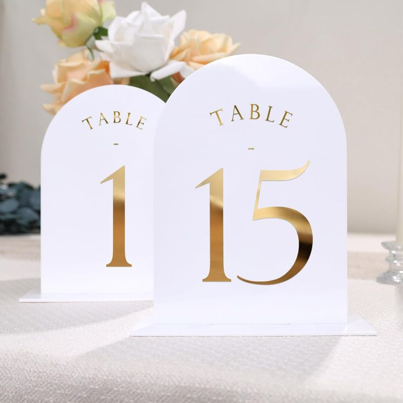 Photo 1 of  White Arch Wedding Table Numbers with Stands 1-15, Gold Foil Printed 5x7 Double sided Acrylic Signs and Holders, Perfect for Centerpiece, Reception, Decoration, Party, Anniversary, Event