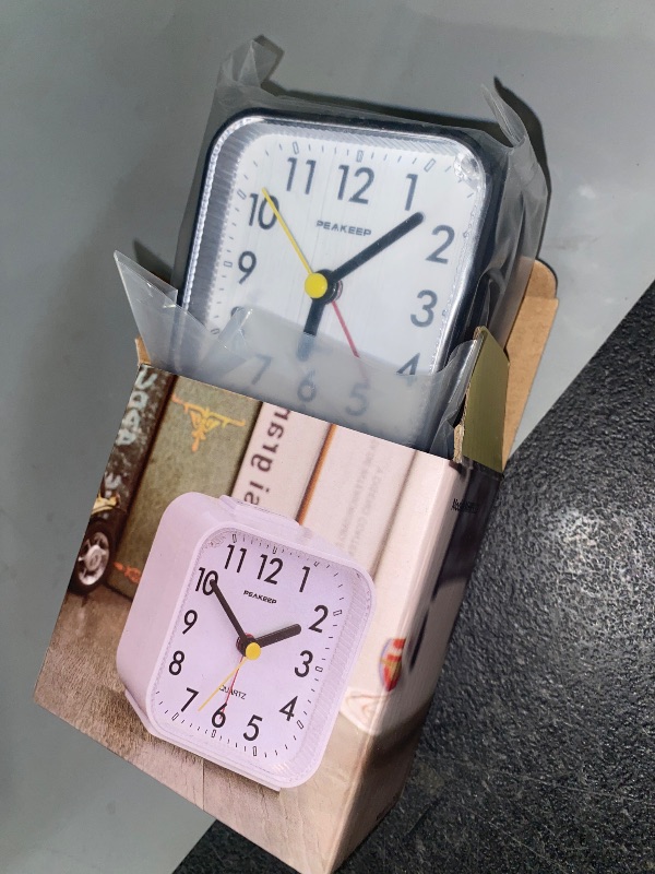 Photo 1 of Peakeep Small Battery Operated Analog Travel Alarm Clock Silent No Ticking, Lighted on Demand and Snooze, Beep Sounds, Gentle Wake, Ascending Alarm, Easy Set (Black)