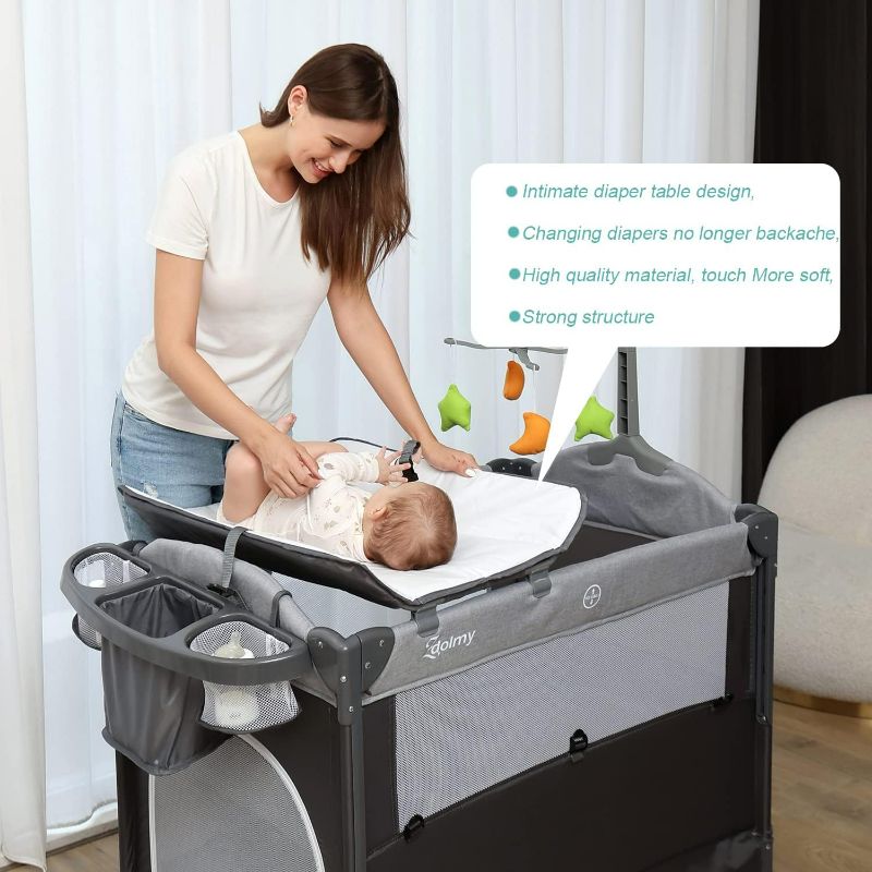 Photo 1 of PLAYARD -  Baby Bedside Sleeper Bassinet, 4-in-1 Pack and Play with Bassinet w/Diaper Changing Table & Storage Bag, 3 Adjustable Heights, Toy Arch & Music, Portable Baby Play Yard with Carry Bag
