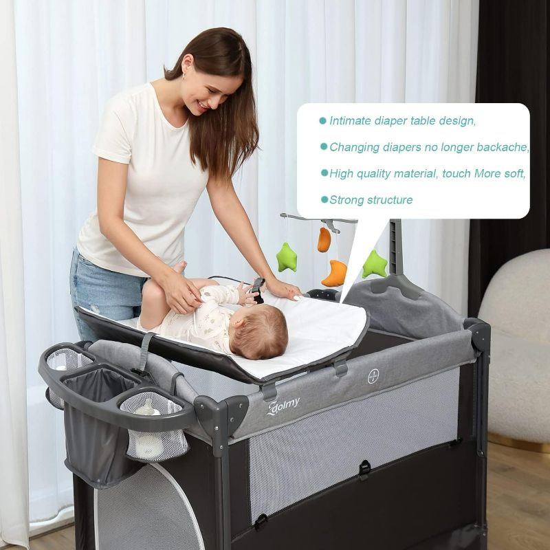 Photo 2 of PLAYARD -  Baby Bedside Sleeper Bassinet, 4-in-1 Pack and Play with Bassinet w/Diaper Changing Table & Storage Bag, 3 Adjustable Heights, Toy Arch & Music, Portable Baby Play Yard with Carry Bag
