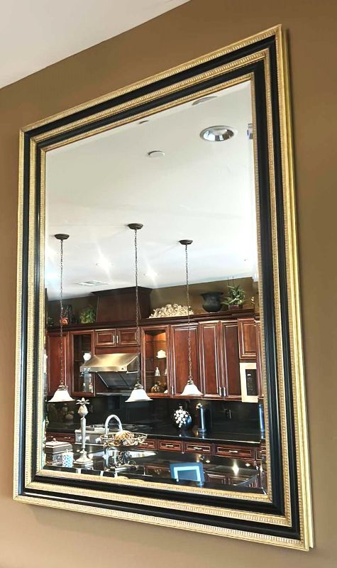 Photo 1 of VERY LARGE ORNATELY FRAMED IN GOLD AND BLACK BEVELED GLASS MIRROR 
57 inches five 44 1/2 inches