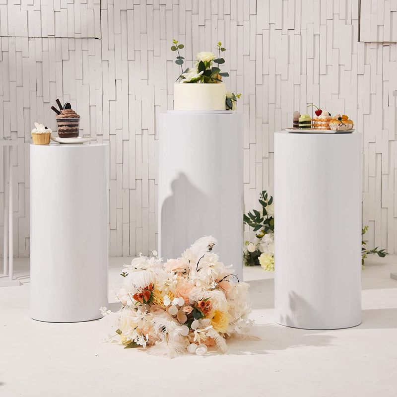 Photo 1 of Metal Display Pedestal Stand,Cylinder Pedestal Stands for Parties Wedding Birthday Decoration,Cake Stand Dessert Display White Set of 3, Size 20" (60cm)& 22" (65cm)& 24" (70cm) Deep Tall
