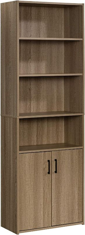 Photo 1 of Sauder Beginnings Bookcase with Doors, L: 24.65" x W: 11.65" x H: 71.14", Summer Oak Finish
