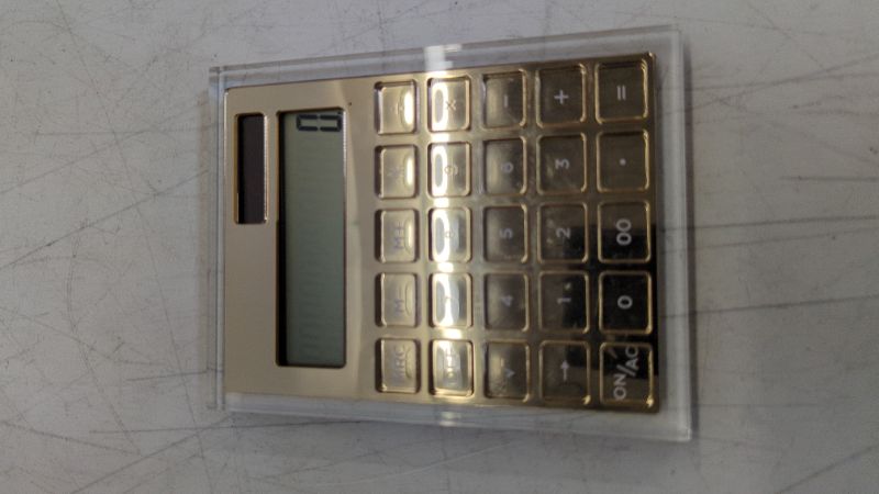 Photo 1 of russell+hazel Acrylic Calculator, Clear with Gold-Toned Hardware.25” x 5.875” x 4.375” (51179)
