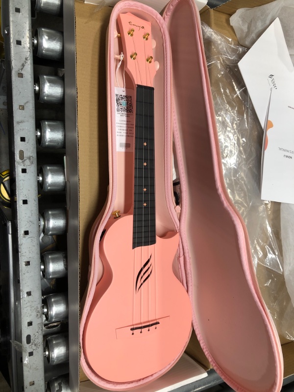 Photo 2 of 
Roll over image to zoom in
Enya Concert Ukulele Nova U 23’’ Carbon Fiber Travel Ukulele with Beginner Kit includes online lessons, case, strap, capo and strings (Pink)