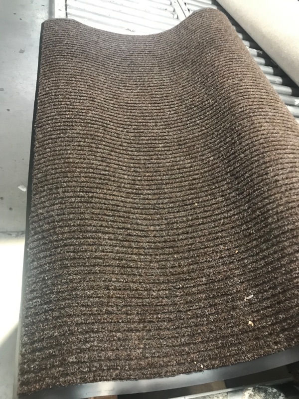 Photo 1 of 4ftx6ft dark brown in color outside rug