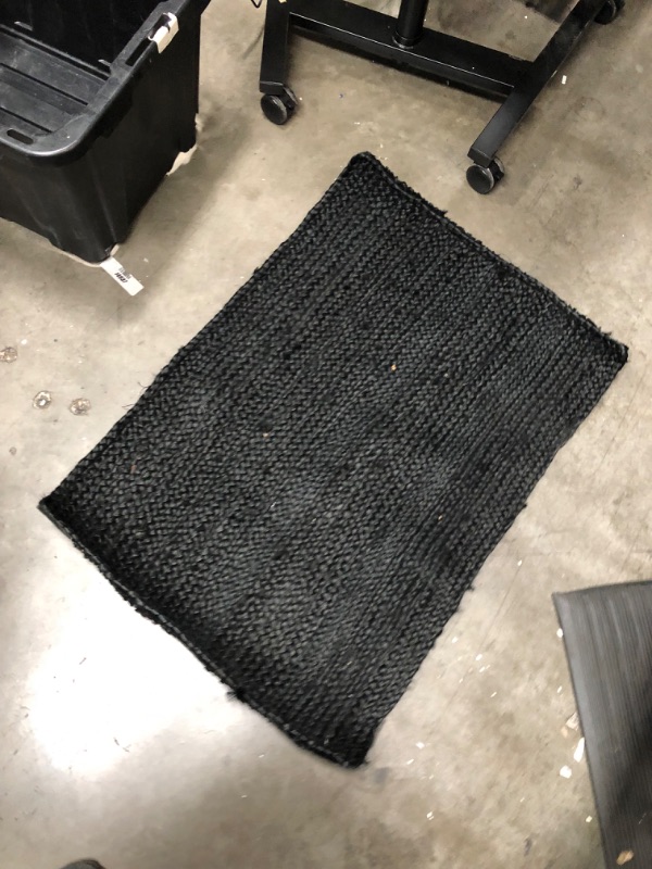 Photo 2 of **used, needs cleaning**
24 inch x 35 inch black natrual rug