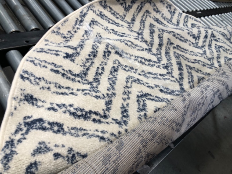 Photo 1 of **used, needs cleaning**
  6ft round  Blue Indoor Geometric Area Rug