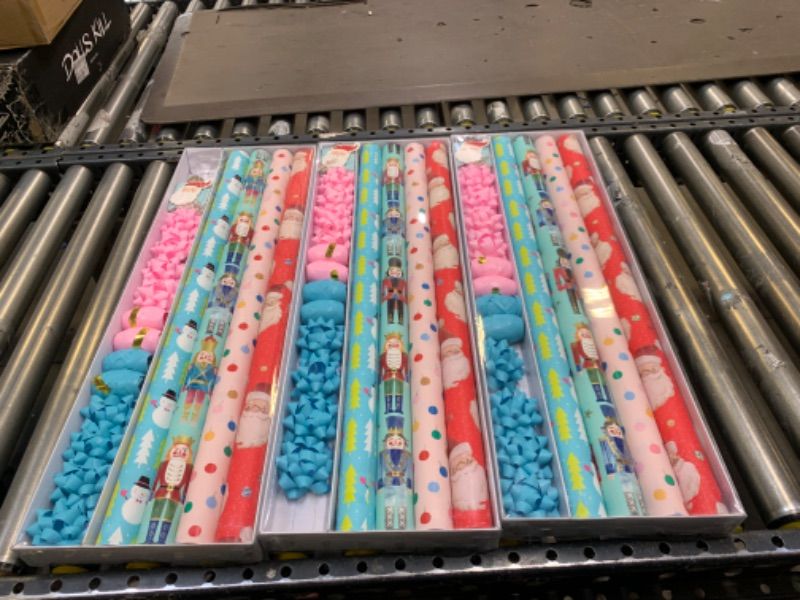 Photo 1 of 3 PACK BUNDLE - Wrapping Paper, Christmas Wrapping Paper for Kids Boys, Girls, baby. 4 Cute Designs Including Santa, Christmas Lights, Snowman, Nutcracker. Includes Decorative Flowers, Ribbons, Labels. Each Roll of Gift Wrap Paper Measures 27.5 In X 13 ft