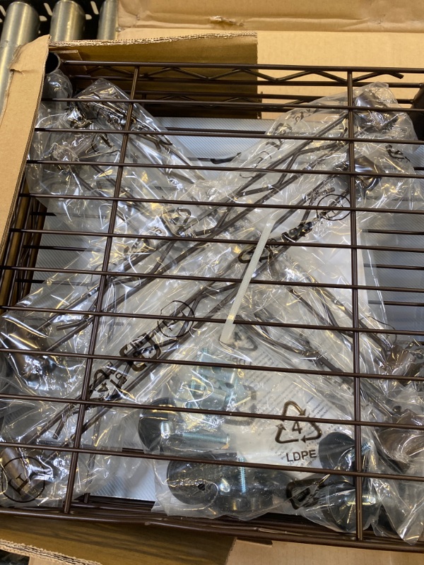 Photo 4 of Amazon Basics Expandable Metal Hanging Storage Organizer Rack Wardrobe with Shelves, 14"-63" x 58"-72", Bronze Bronze Organizer