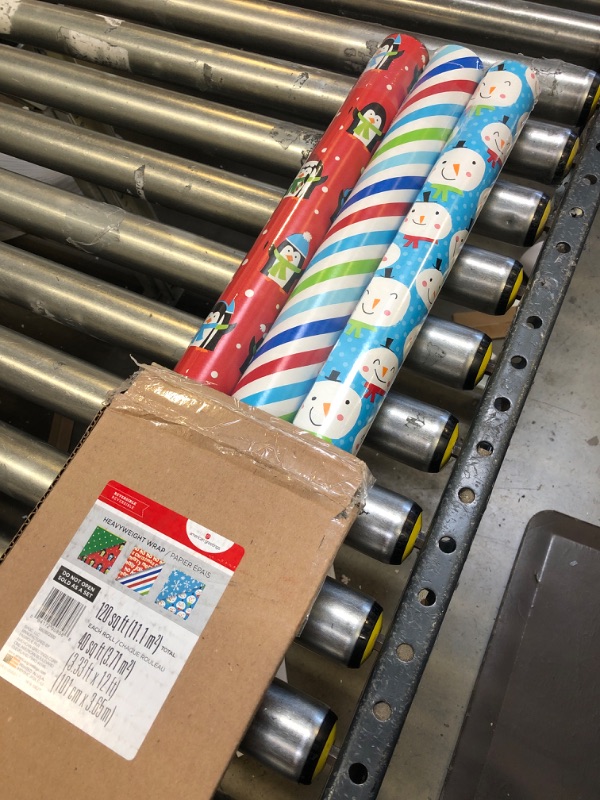 Photo 2 of American Greetings Christmas Reversible Wrapping Paper Bundle, Stripes, Blue Snowmen And Red Penguins (3 Rolls, 120 sq. ft.)