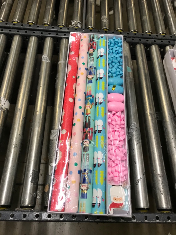 Photo 2 of 2 PK Wrapping Paper, Christmas Wrapping Paper for Kids Boys, Girls, baby. 4 Cute Designs Including Santa, Christmas Lights, Snowman, Nutcracker. Includes Decorative Flowers, Ribbons, Labels. Each Roll of Gift Wrap Paper Measures 27.5 In X 13 ft