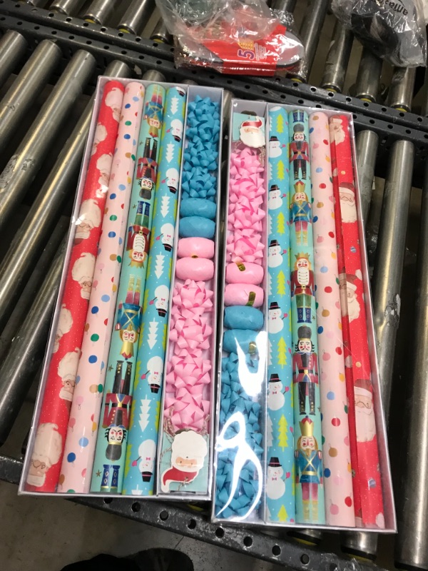 Photo 2 of 2 PK Wrapping Paper, Christmas Wrapping Paper for Kids Boys, Girls, baby. 4 Cute Designs Including Santa, Christmas Lights, Snowman, Nutcracker. Includes Decorative Flowers, Ribbons, Labels. Each Roll of Gift Wrap Paper Measures 27.5 In X 13 ft