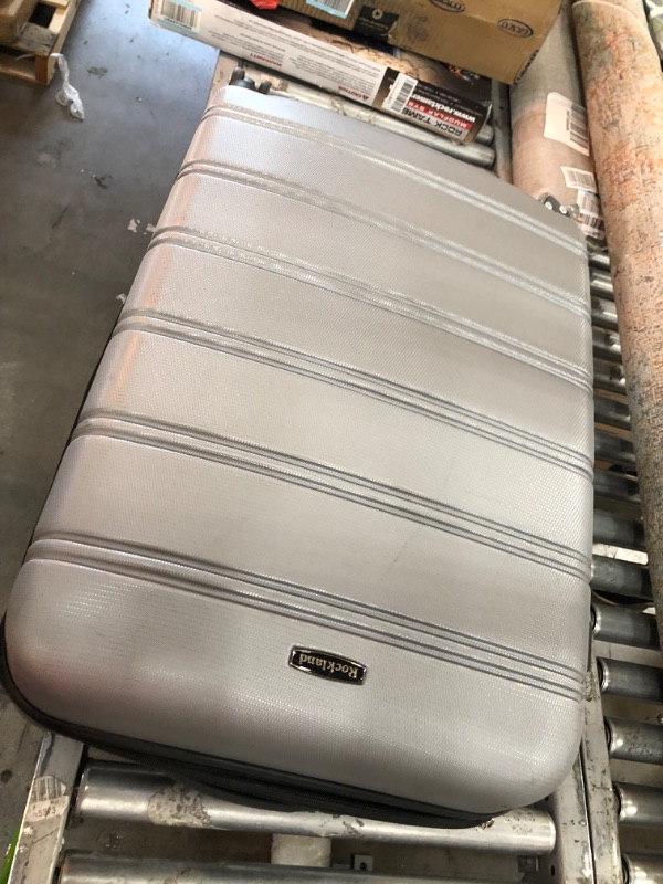 Photo 3 of **damaged**
Rockland Melbourne Hardside Expandable Spinner Wheel Luggage, Silver, 3-Piece Set (20/24/28)
