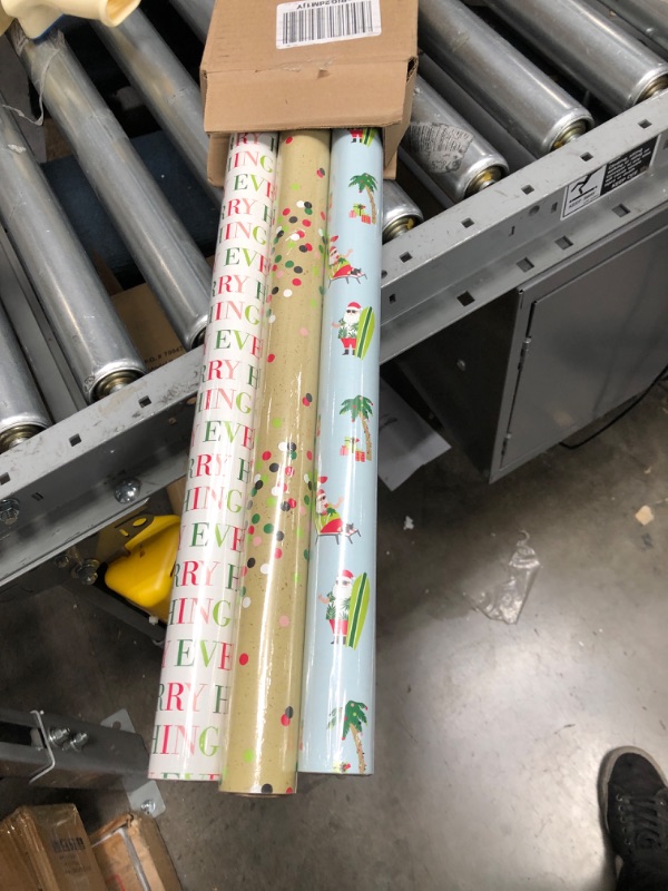 Photo 2 of Hallmark Beach Christmas Wrapping Paper with Cutlines and Optional DIY Bow Templates on Reverse (3 Rolls: 120 Sq. Ft. Ttl) Tropical Santa Claus, Pink
