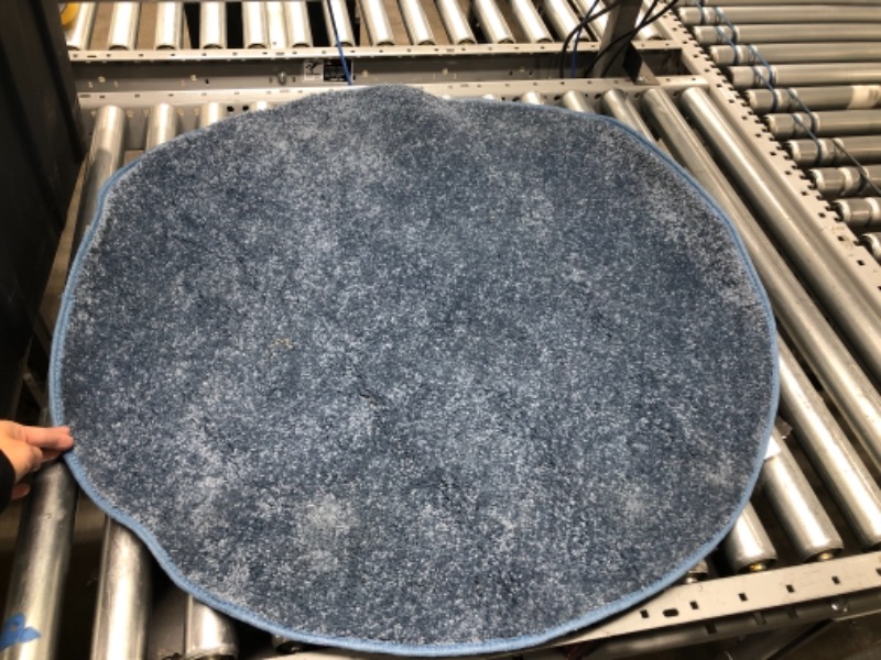 Photo 1 of 34" round blue rug.