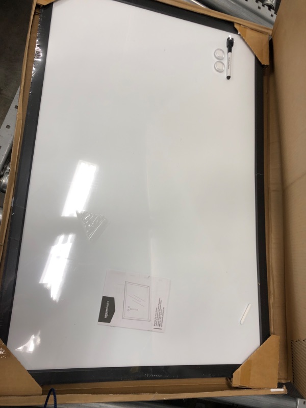 Photo 2 of Amazon Basics Magnetic Dry Erase White Board, 35 x 23-Inch Whiteboard - Black Wooden Frame 23"x35" Magnetic, Wood Frame