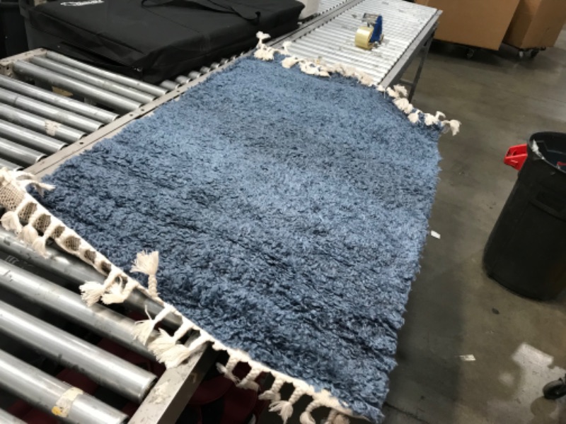 Photo 1 of **used needs cleaning**
36in x 60in navy blue and white fluffy rug, view photos