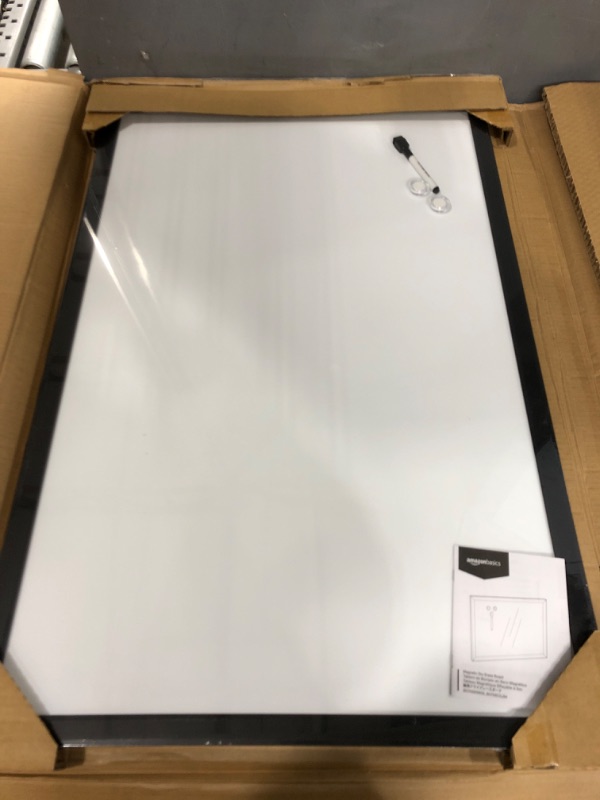 Photo 2 of Amazon Basics Magnetic Dry Erase White Board, 35 x 23-Inch Whiteboard - Black Wooden Frame 23"x35" Magnetic, Wood Frame